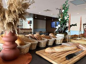 a table with baskets and loaves of bread on it at ibis Styles Nimes Gare Centre in Nîmes