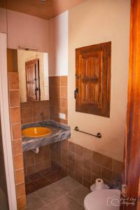 a bathroom with a sink and a toilet at Casa Rural TorreMontero Apartamentos in Hornos el Viejo