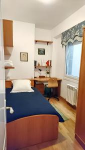 Schlafzimmer mit einem Bett, einem Schreibtisch und einem Fenster in der Unterkunft 3 bedrooms apartement at A Coruna 200 m away from the beach with wifi in A Coruña