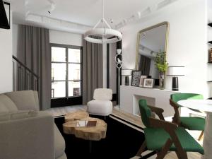 un soggiorno con divano e tavolo di Balthazar Hôtel & Spa Rennes - MGallery Hotel Collection a Rennes