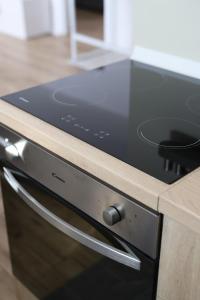 a black stove top oven in a kitchen at Apartman BUCO in Đakovo