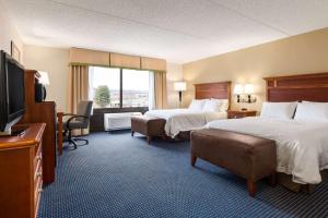 a hotel room with two beds and a flat screen tv at Hampton Inn Warrenton, Va in Warrenton