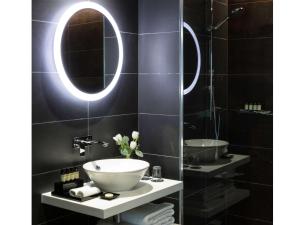 a bathroom with a sink and a mirror at Pullman Liverpool in Liverpool