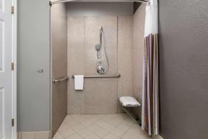 a bathroom with a shower stall with a toilet at La Quinta by Wyndham Belton - Temple South in Belton
