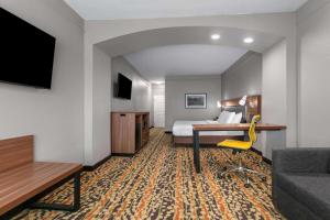 a hotel room with a bed and a desk at La Quinta by Wyndham Belton - Temple South in Belton