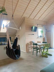 a hammock hanging from a ceiling in a room at Homemade Apartment in Liebshausen