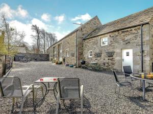 a patio with chairs and a table in front of a building at 3 Bed in Blanchland CN110 