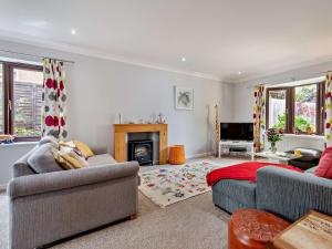 a living room with two couches and a fireplace at 4 Bed in Wareham 77511 in Stoborough