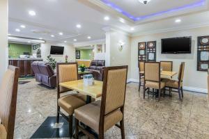 a restaurant with a table and chairs and a living room at Quality Inn & Suites Atlanta Airport South in Atlanta