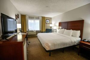 a hotel room with a bed and a flat screen tv at Comfort Inn Yreka I-5 in Yreka