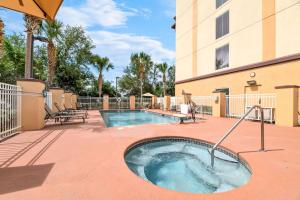 a hot tub on a patio next to a building at Comfort Suites Orlando Airport in Orlando