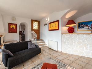 a living room with a couch and a staircase at Apartment Casa Marcelli by Interhome in SantʼAntonino
