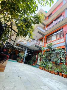 a building with potted plants in front of it at Hotel Atlantic in Kathmandu