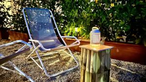 a blue folding chair sitting next to a wooden stump at The Dream in Massa Lubrense
