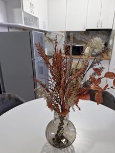 a vase filled with dried plants on a table at APART SUNNY BAY a SUNNY BEACH in Sunny Beach