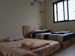 Postel nebo postele na pokoji v ubytování 南州民宿 NanChou Guesthouse