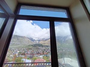 a window with a view of a city at Belas guesthouse in Stepantsminda