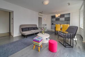 a living room with a couch and chairs and a table at Silver Apartment With Hot Tub And Balcony - Happy Rentals in Zagreb