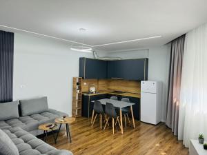a living room with a couch and a table at Apartamente Tirana in Tirana