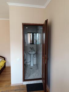 a bathroom with a toilet and a sink at Belas guesthouse in Stepantsminda