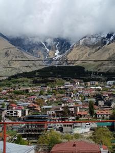 a small town in front of a mountain at Belas guesthouse in Stepantsminda