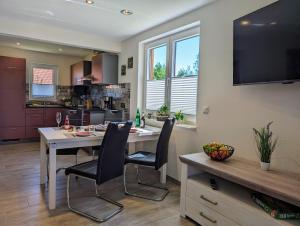 a kitchen and dining room with a table and chairs at Premiumferienhaus Mara in Hasselfelde +28 photos