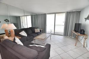 a living room with a couch and a tv at 1412 Waters Edge Resort condo in Myrtle Beach