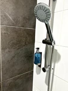 a shower with a shower head in a bathroom at Bamboo Guesthouse in Bournemouth