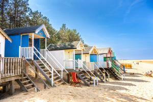 a row of beach huts on the beach at Gallery Cottage in Wighton