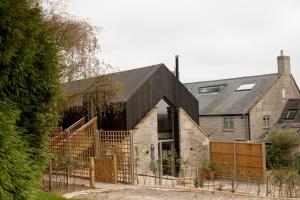 an external view of a house with a black roof at The Old Winery Cottage No1 in Shepton Mallet