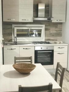 a kitchen with a table with a bowl on it at One bedroom apartement with furnished terrace and wifi at Melendugno 5 km away from the beach in Melendugno