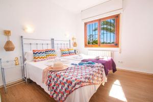 a bedroom with a bed with a hat on it at Villa Cohete - Plusholidays in Ifach +36 photos