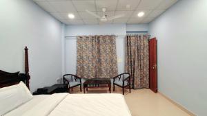 um quarto com uma cama, uma mesa e cadeiras em Dev Sneh Residency em Jaipur