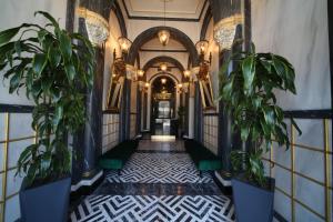 a hallway of a building with potted plants at Nordstern Hotel Galata in Istanbul