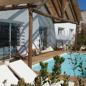 a villa with a swimming pool and a patio at Casa Calmar in Porto Covo