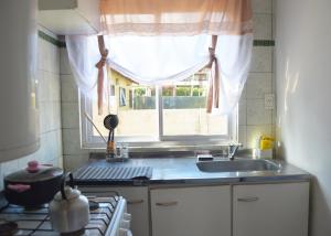 a kitchen with a sink and a window at Gemelas Andinas in Trevelín +19 photos