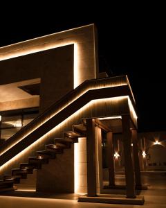 a building with a staircase lit up at night at Casa Élan for VIP guests 2 Pools in Ras al Khaimah