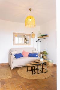 a living room with a couch and a table at Estudio vistas al mar y a 5 minutos playa Estartit in L'Estartit