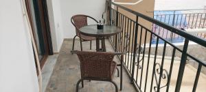 a small table and two chairs on a balcony at Diamond apartments in Artemida