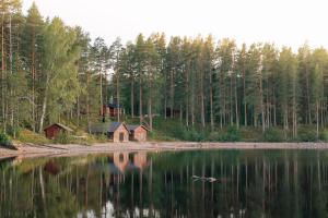 a house on the shore of a lake at Off the grid in the abandoned village of Ejheden in Voxnabruk