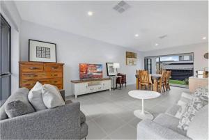 a living room with a couch and a table at Brand New Home In Oran Park in Narellan