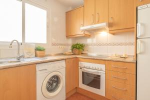 a kitchen with a washing machine and a sink at Apt Parque Fuengirola 800mt From Sea - Happy rentals in Fuengirola