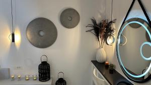 a bathroom with a mirror and a sink with lights at Miracles Suites by Anastasia Princess, Adults Only in Perissa