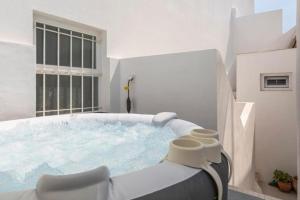 a hot tub in a white room with a window at Floripes Stylish in Olhão +47 photos