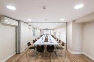 a long conference room with a long table and chairs at Melia Plaza Valencia in Valencia