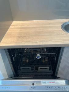 an oven with a wooden counter top on top of it at A4 Luxury Apartment in Wrocław