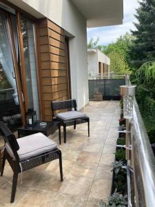 a patio with two chairs and a table at A4 Luxury Apartment in Wrocław