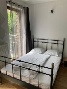 a bed in a bedroom with a large window at A4 Luxury Apartment in Wrocław