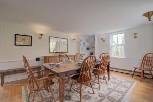 a dining room with a wooden table and chairs at Short drive to town and popular beaches in Orleans
