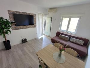 a living room with a couch and a table at Apartments Sun & Sea in Dugi Rat